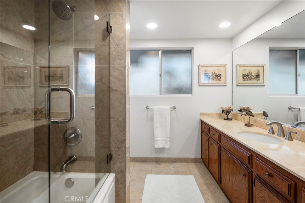 3495 Ridgecrest Drive Carlsbad, CA 92008 - Photo 34 of 42 a bathroom with a tub sink shower and mirror