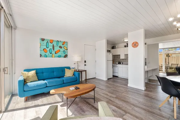 a living room with furniture and a kitchen view
