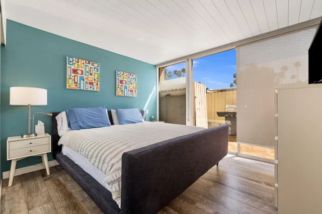 a bed room with a bed and a night stand