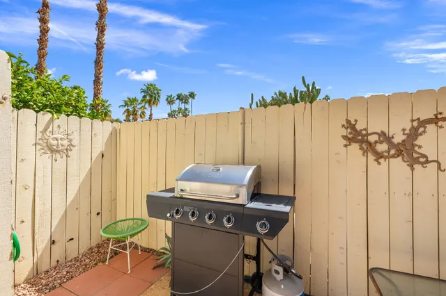 a view of a chairs and table in patio