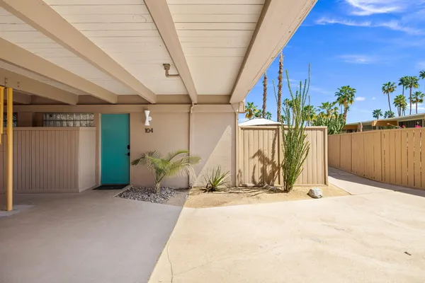 a view of potted plants with wooden fence