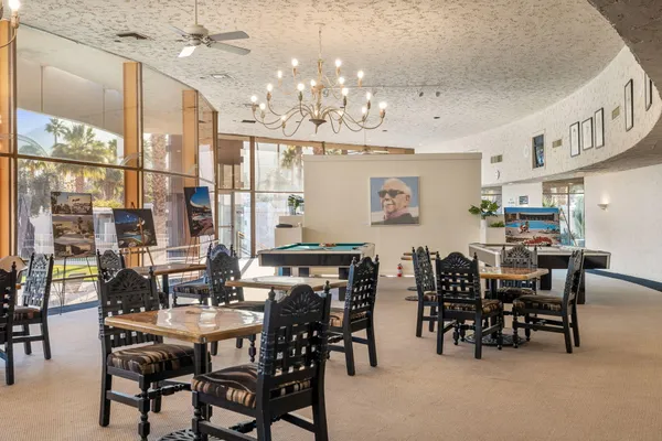 a room with pool table and windows