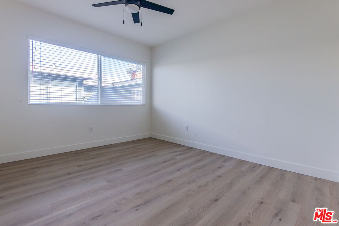 1303 Beryl Street, Unit B Redondo Beach, CA 90277 - Photo 12 of 22 an empty room with wooden floor and windows