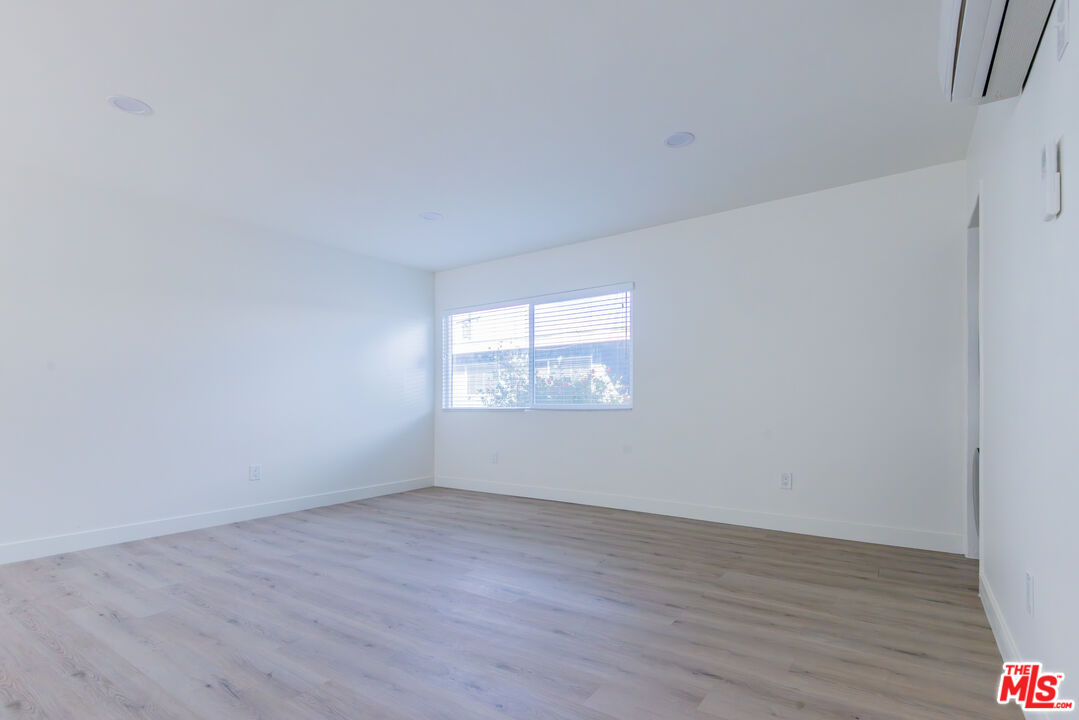 1303 Beryl Street, Unit B Redondo Beach, CA 90277 - Photo 22 of 22 a view of an empty room with wooden floor and a window