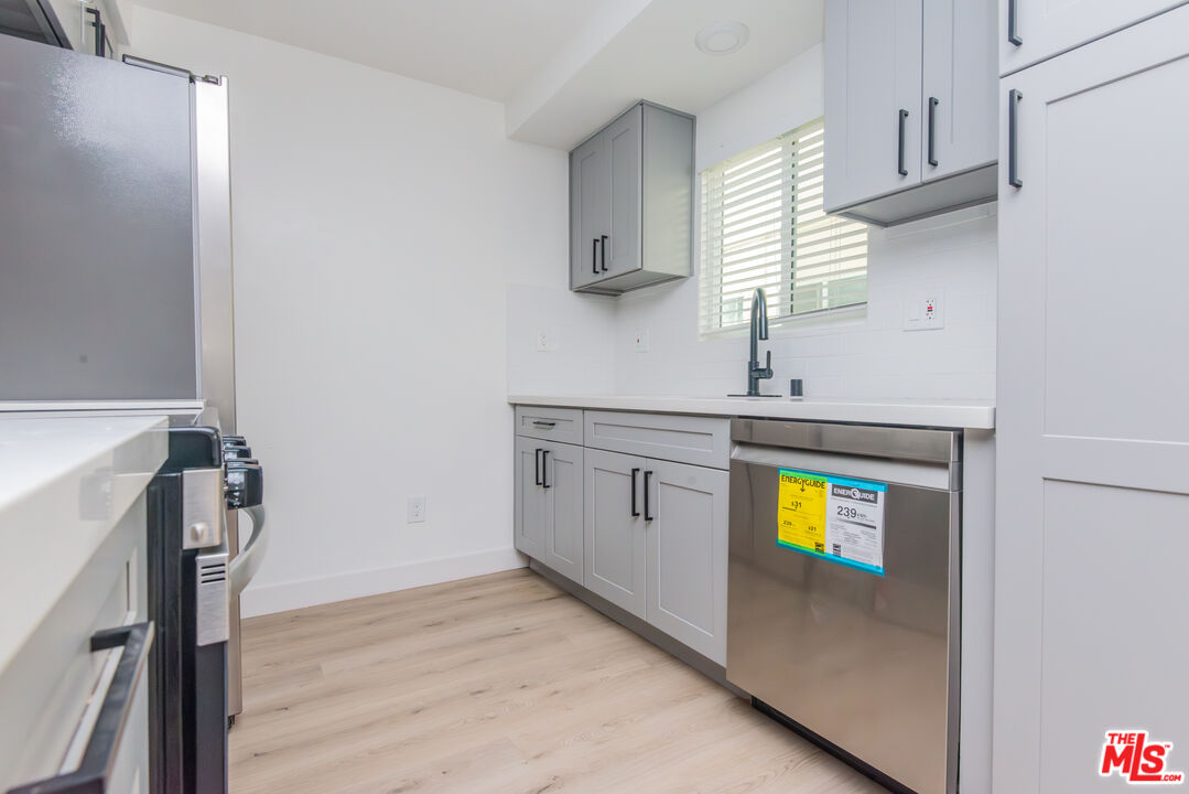 1303 Beryl Street, Unit B Redondo Beach, CA 90277 - Photo 8 of 22 a kitchen with a sink a stove and cabinets