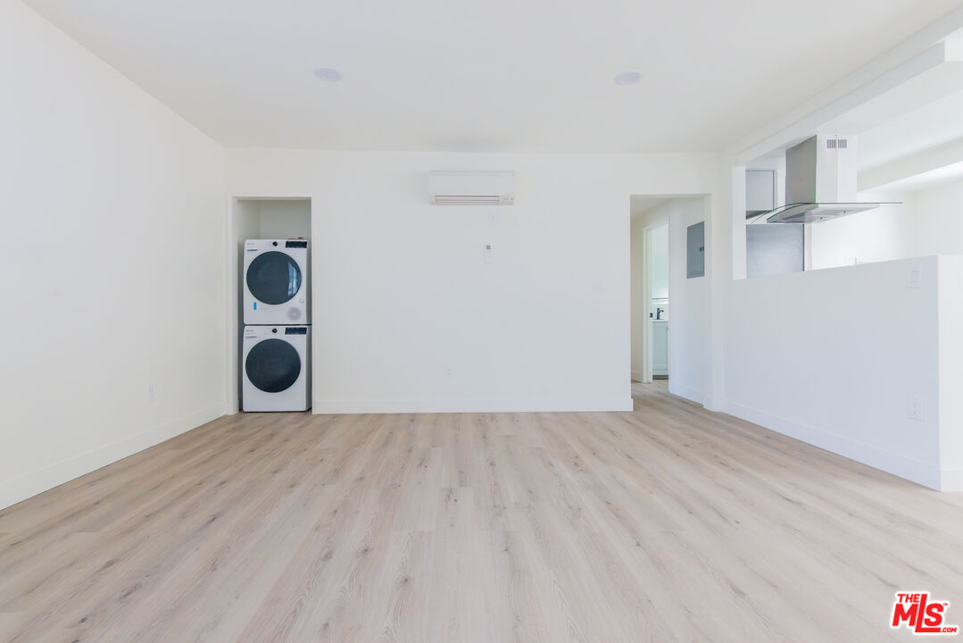 1303 Beryl Street, Unit B Redondo Beach, CA 90277 - Photo 9 of 22 an empty room with wooden floor and windows