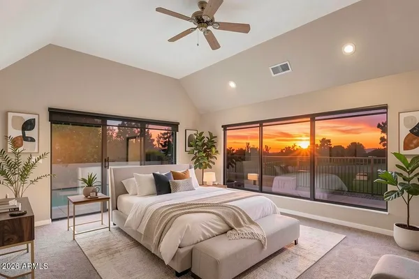 a bedroom with a large bed and a window