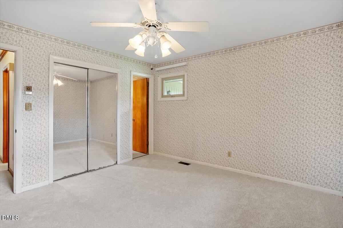3804 Bland Road Raleigh, NC 27609 - Photo 23 of 34 an empty room with a ceiling fan and shower