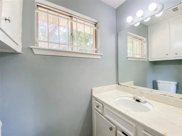 a bathroom with a sink and a window