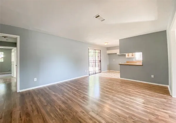 a view of wooden floor and windows in a room