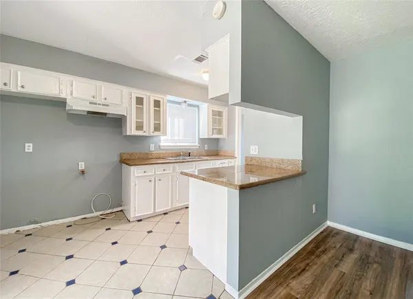 a kitchen with granite countertop a sink and cabinets