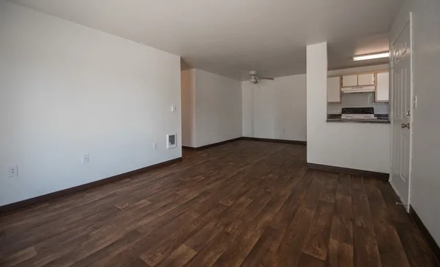 a view of a kitchen with wooden floor and electronic appliances