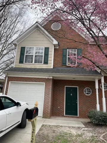a view of a house with a yard and garage