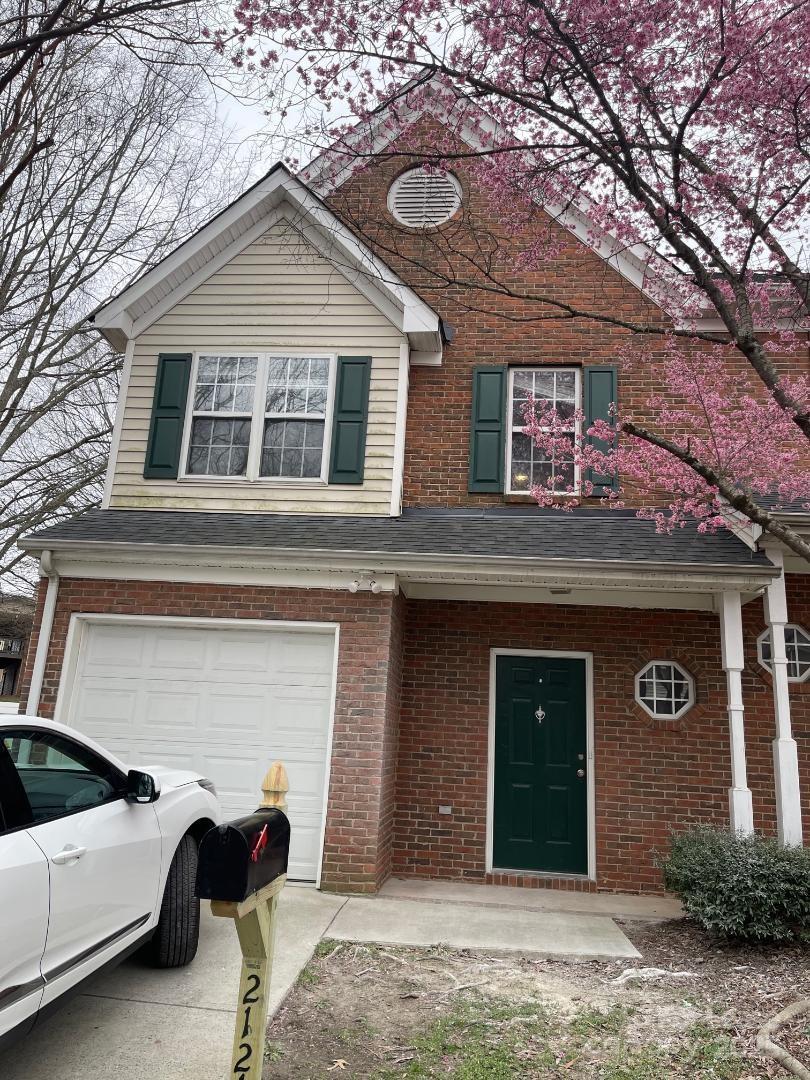 a view of a house with a yard and garage