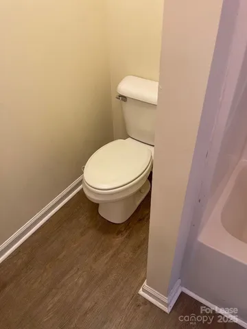 a white toilet sitting next to a white sink