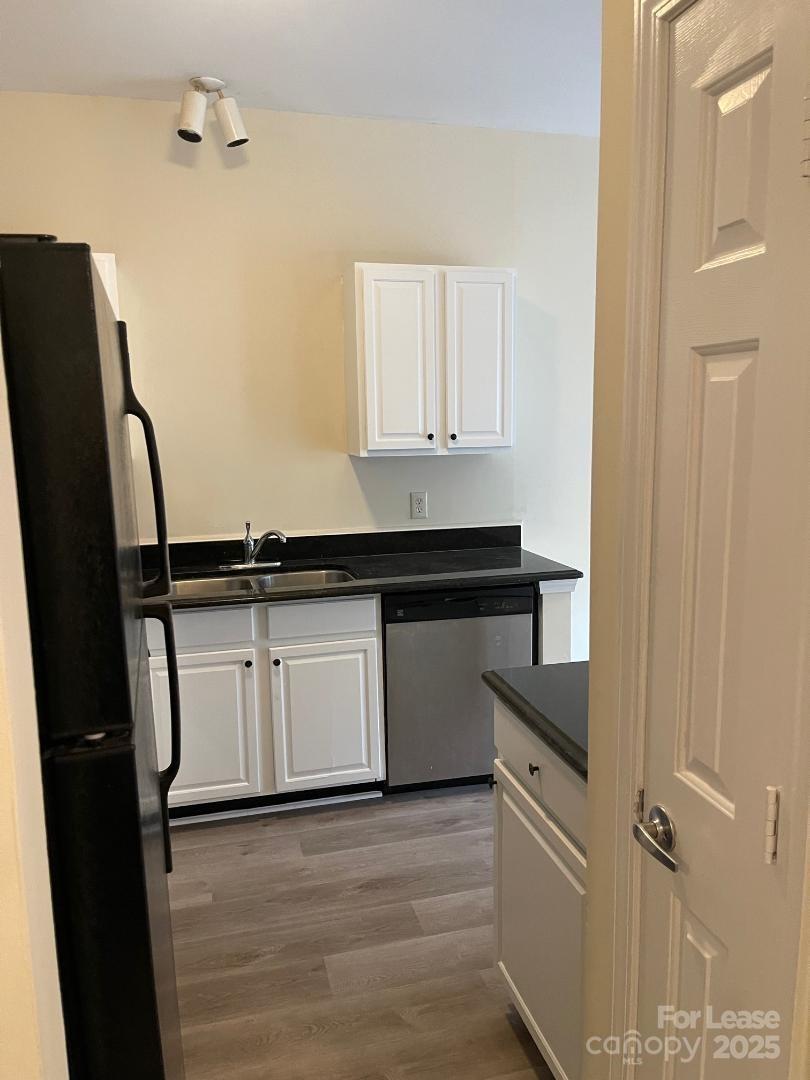2121 Lennox Square Road Charlotte, NC 28210 - Photo 17 of 17 a kitchen with a refrigerator and white cabinets