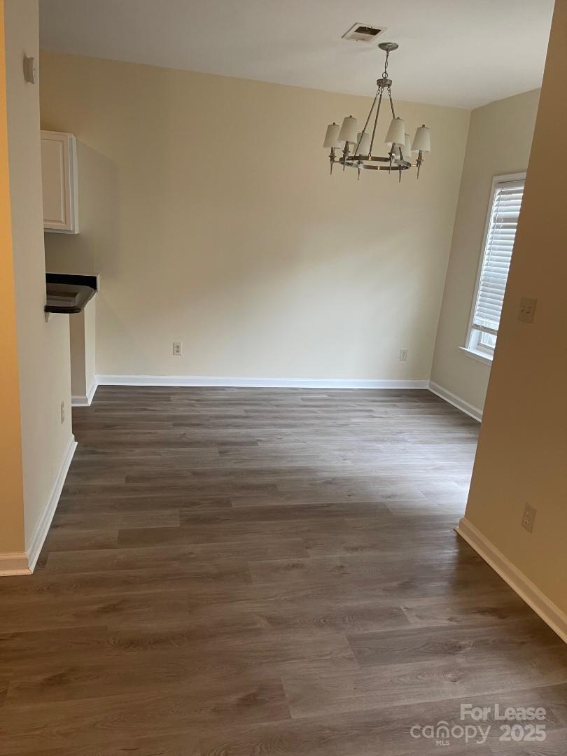 2121 Lennox Square Road Charlotte, NC 28210 - Photo 4 of 17 a view of a room with wooden floor and staircase