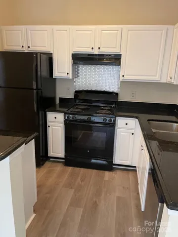 a kitchen with a stove and a refrigerator