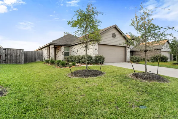 a view of a house with a yard and sitting area