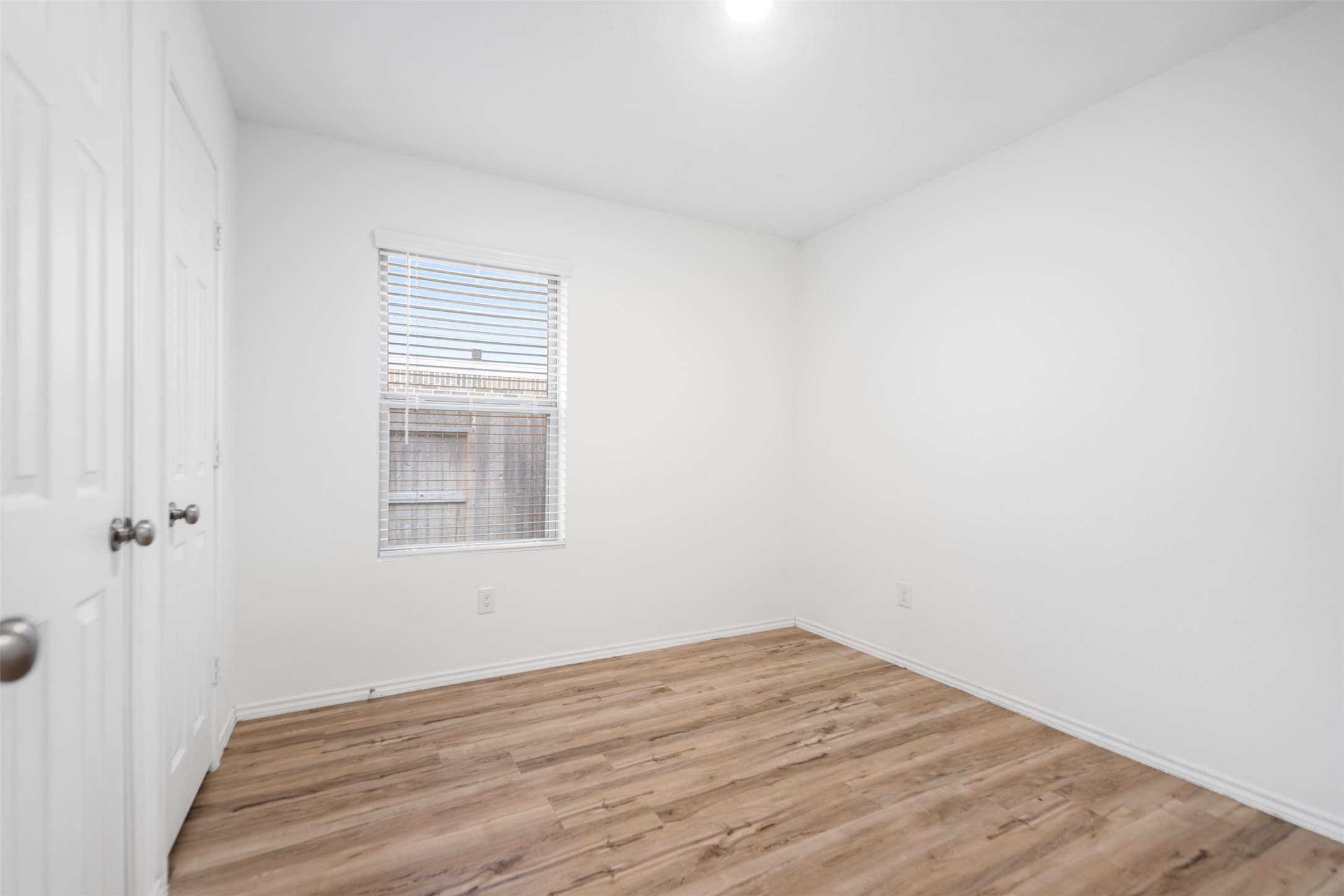 14519 Broadbury Pond Road Rosharon, TX 77583 - Photo 14 of 22 a view of an empty room with wooden floor and a window