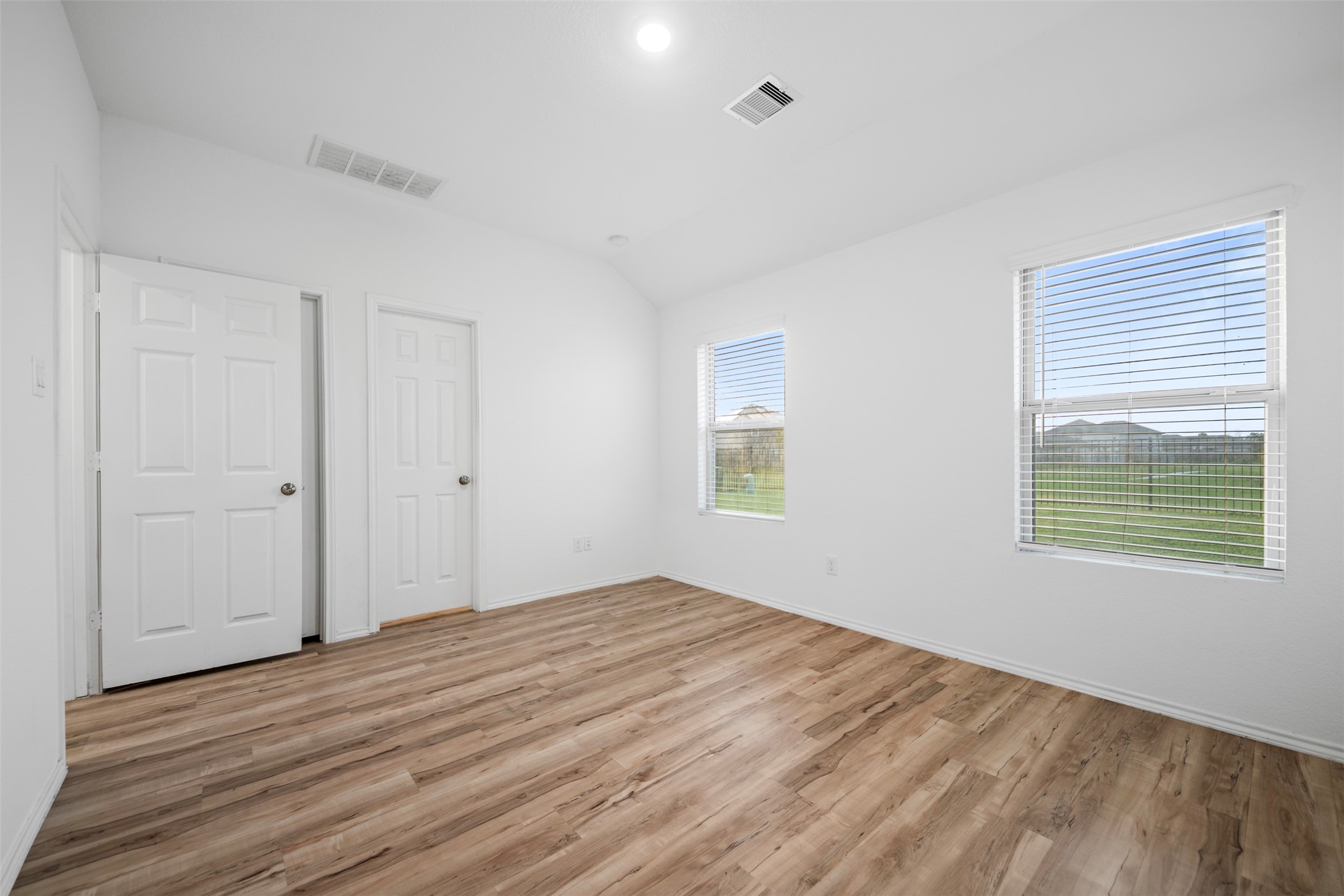 14519 Broadbury Pond Road Rosharon, TX 77583 - Photo 15 of 22 a view of an empty room with wooden floor and a window
