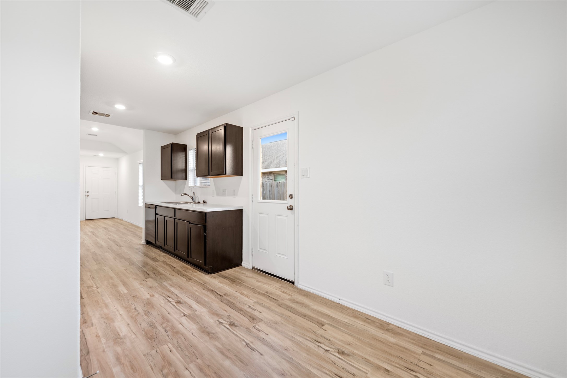 14519 Broadbury Pond Road Rosharon, TX 77583 - Photo 20 of 22 a large white kitchen with a sink and dishwasher