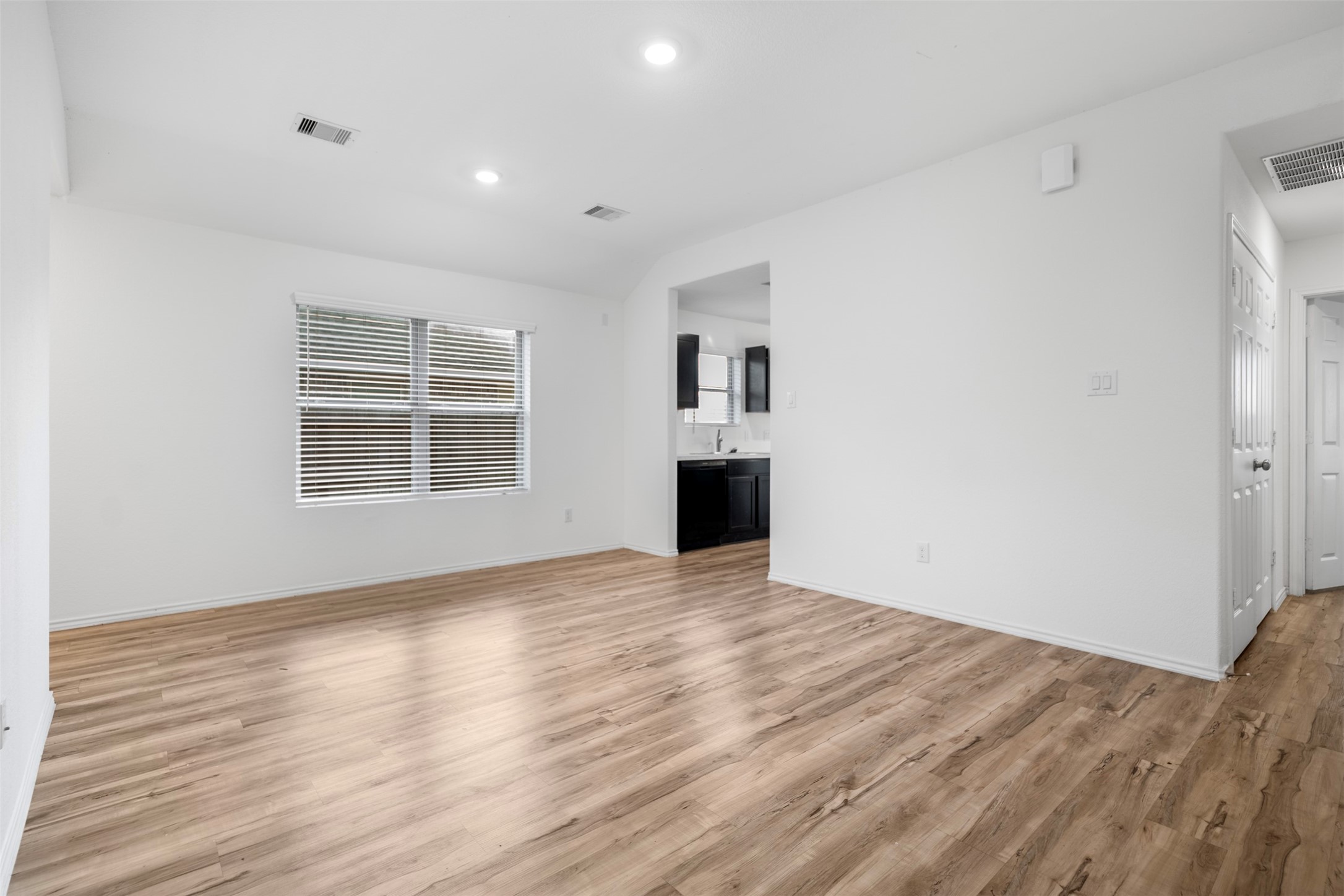 14519 Broadbury Pond Road Rosharon, TX 77583 - Photo 5 of 22 a view of an empty room with wooden floor and a window