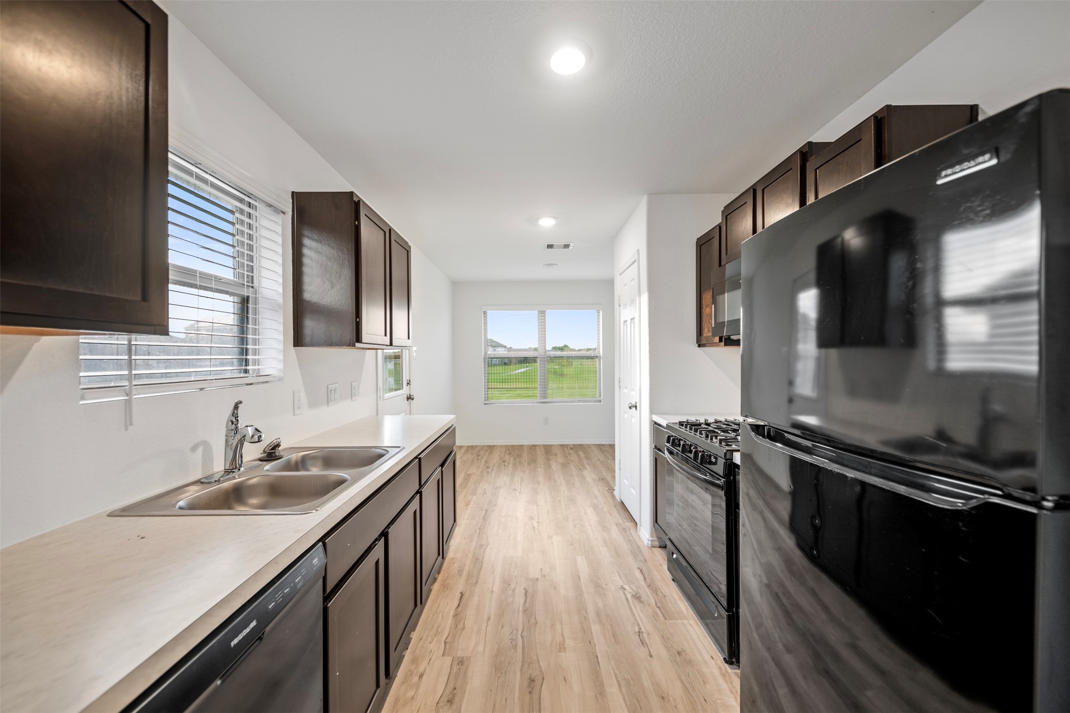14519 Broadbury Pond Road Rosharon, TX 77583 - Photo 6 of 22 a kitchen with a sink stove and cabinets