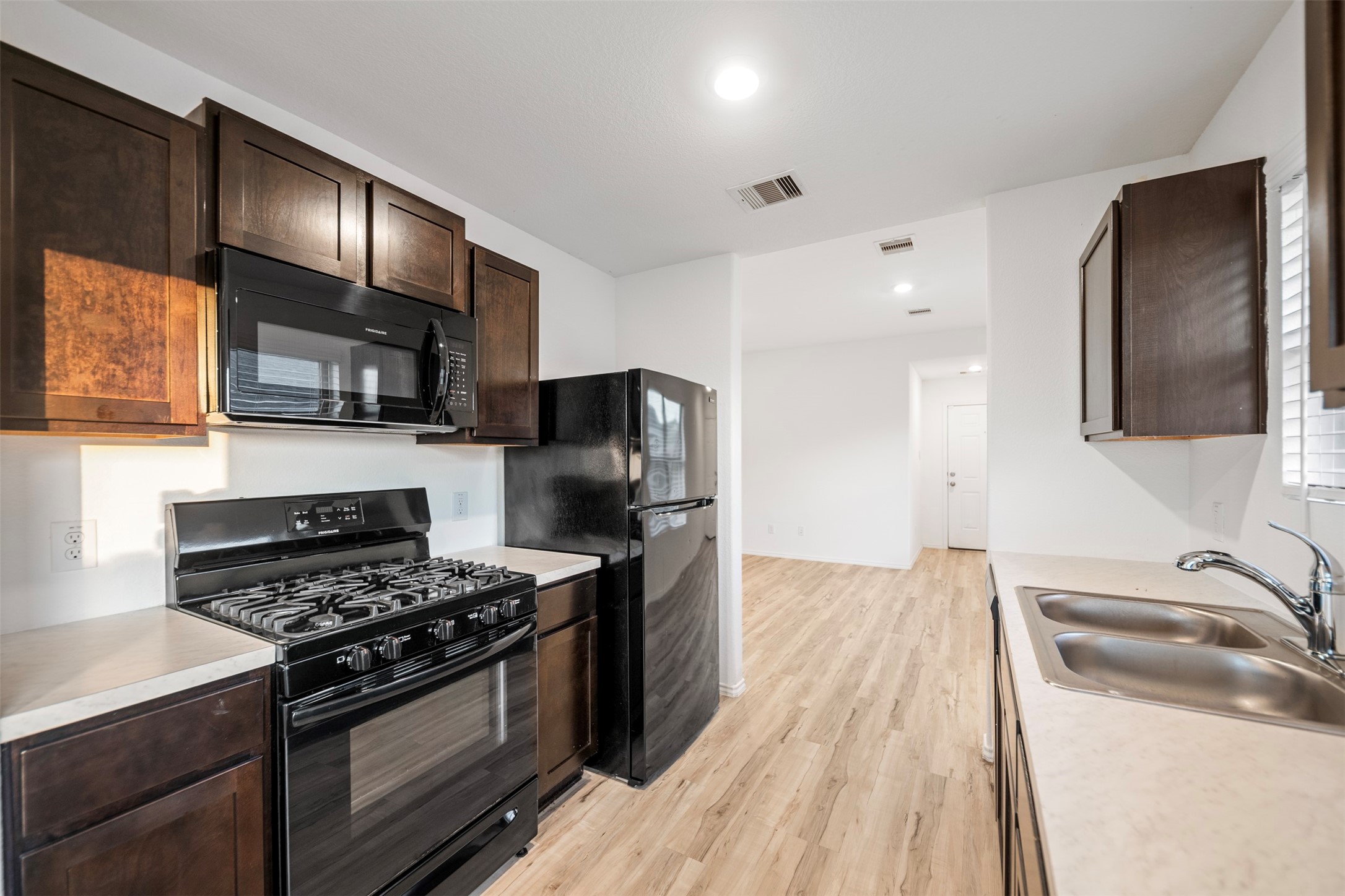 14519 Broadbury Pond Road Rosharon, TX 77583 - Photo 7 of 22 a kitchen with stainless steel appliances a sink stove and refrigerator