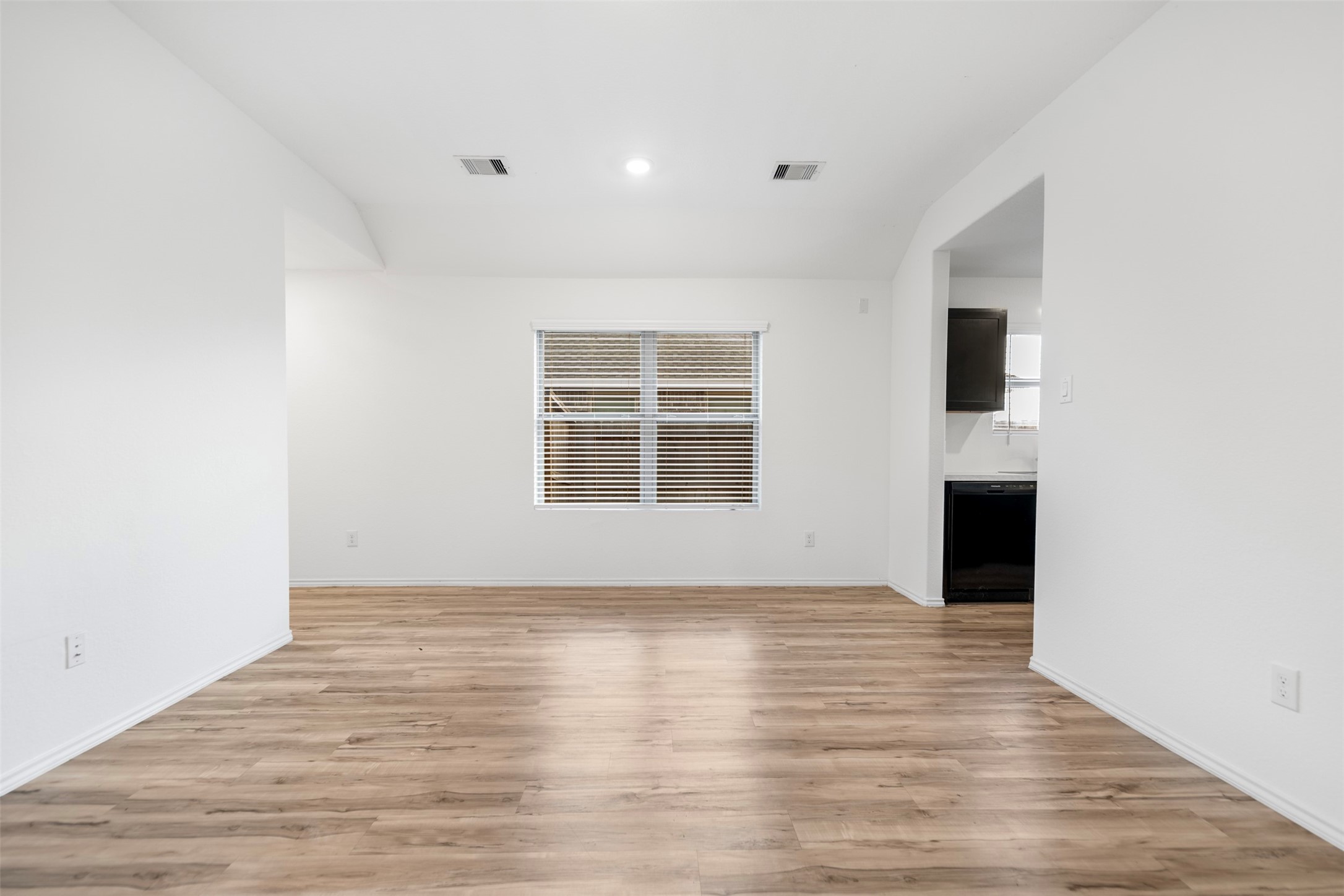 14519 Broadbury Pond Road Rosharon, TX 77583 - Photo 8 of 22 a view of empty room with wooden floor and fireplace