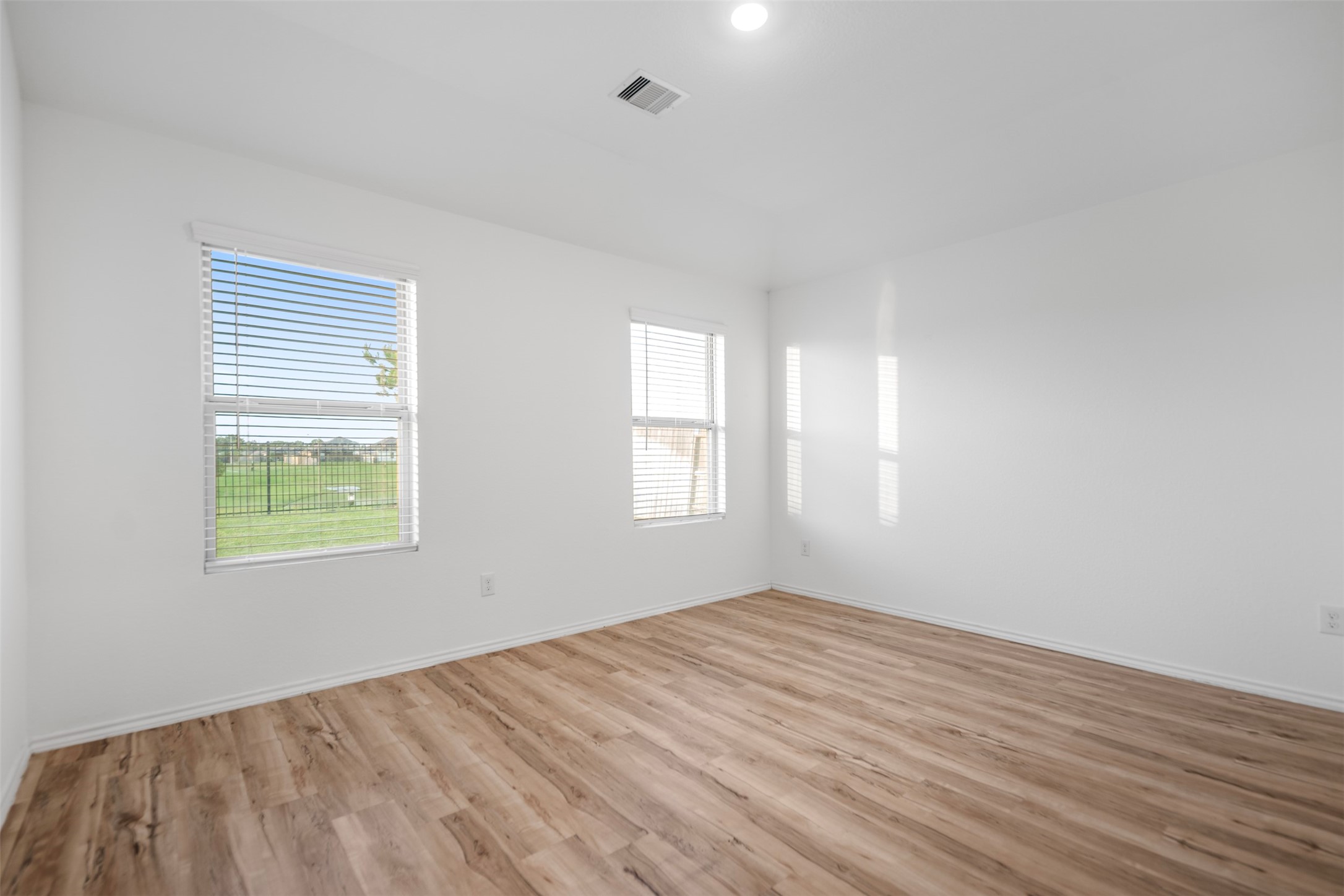 14519 Broadbury Pond Road Rosharon, TX 77583 - Photo 9 of 22 a view of an empty room with wooden floor and a window