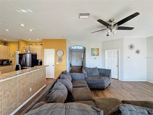 a living room with furniture a ceiling fan and a rug