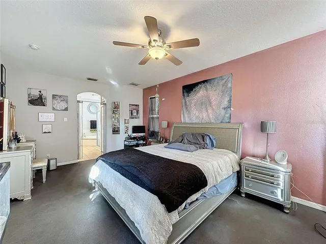 a living room with a couch and a ceiling fan