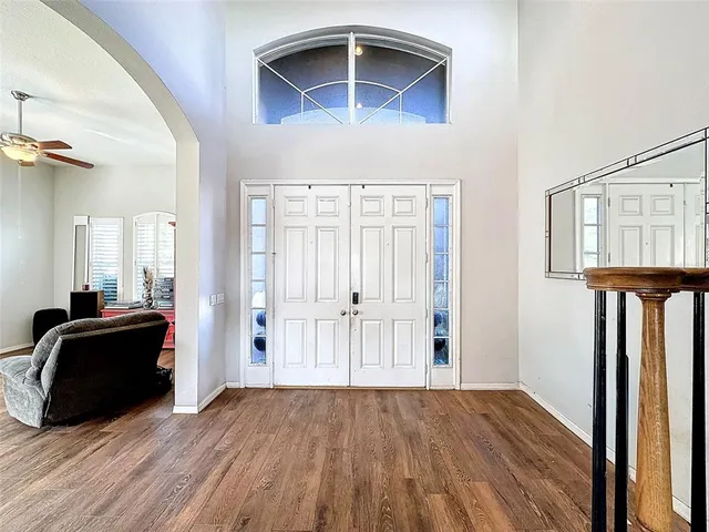 a view of entryway and hall with wooden floor