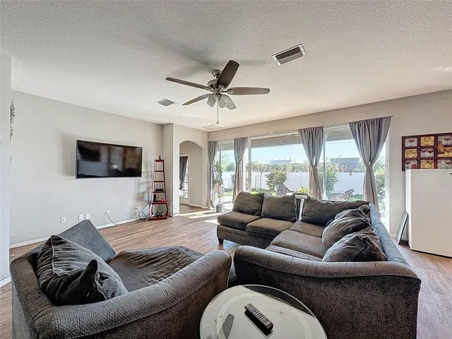 a living room with furniture and a large window