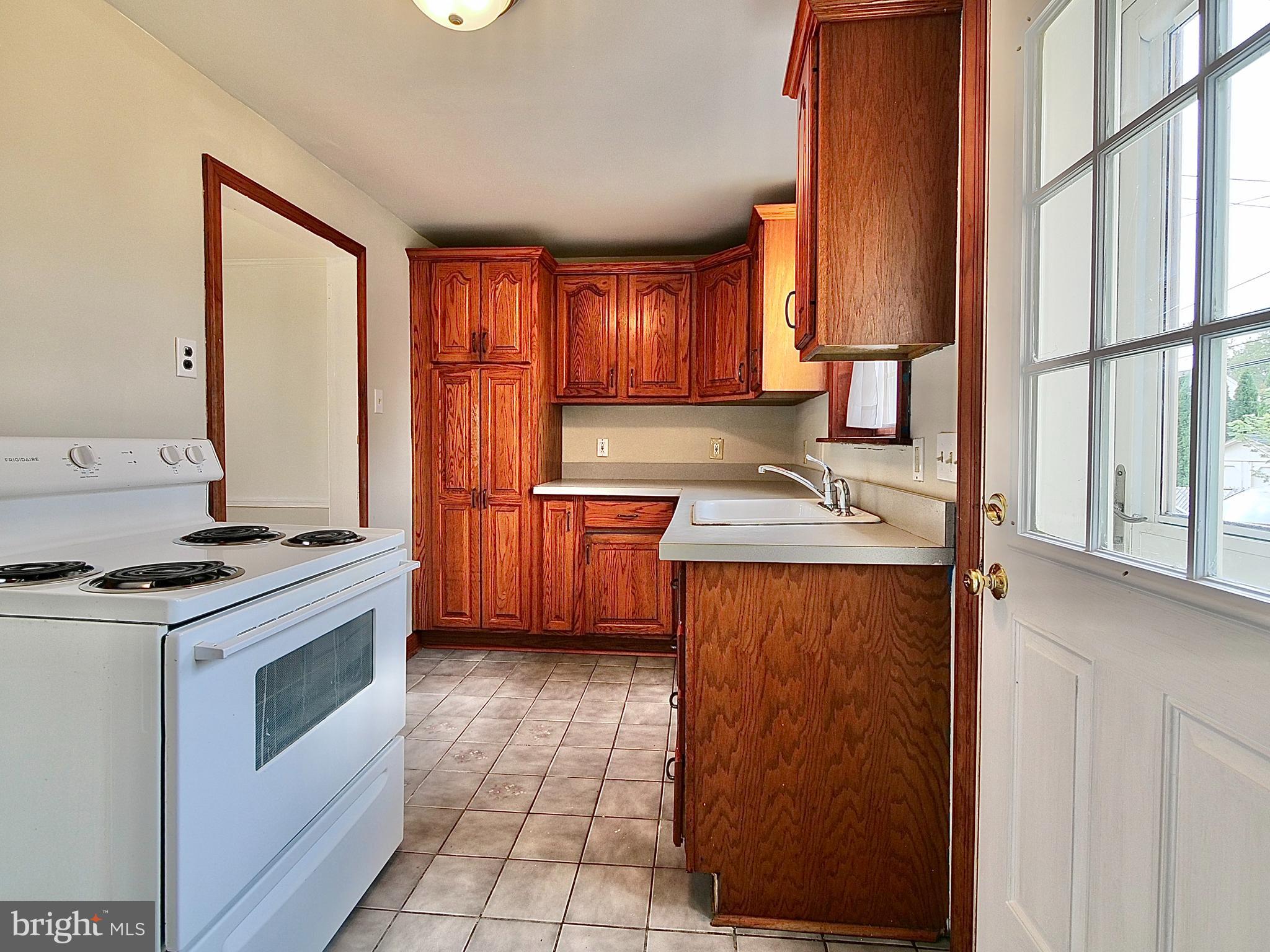 206 Earlington Road Havertown, PA 19083 - Photo 22 of 60 Back exit door from kitchen. Pantry cabinet