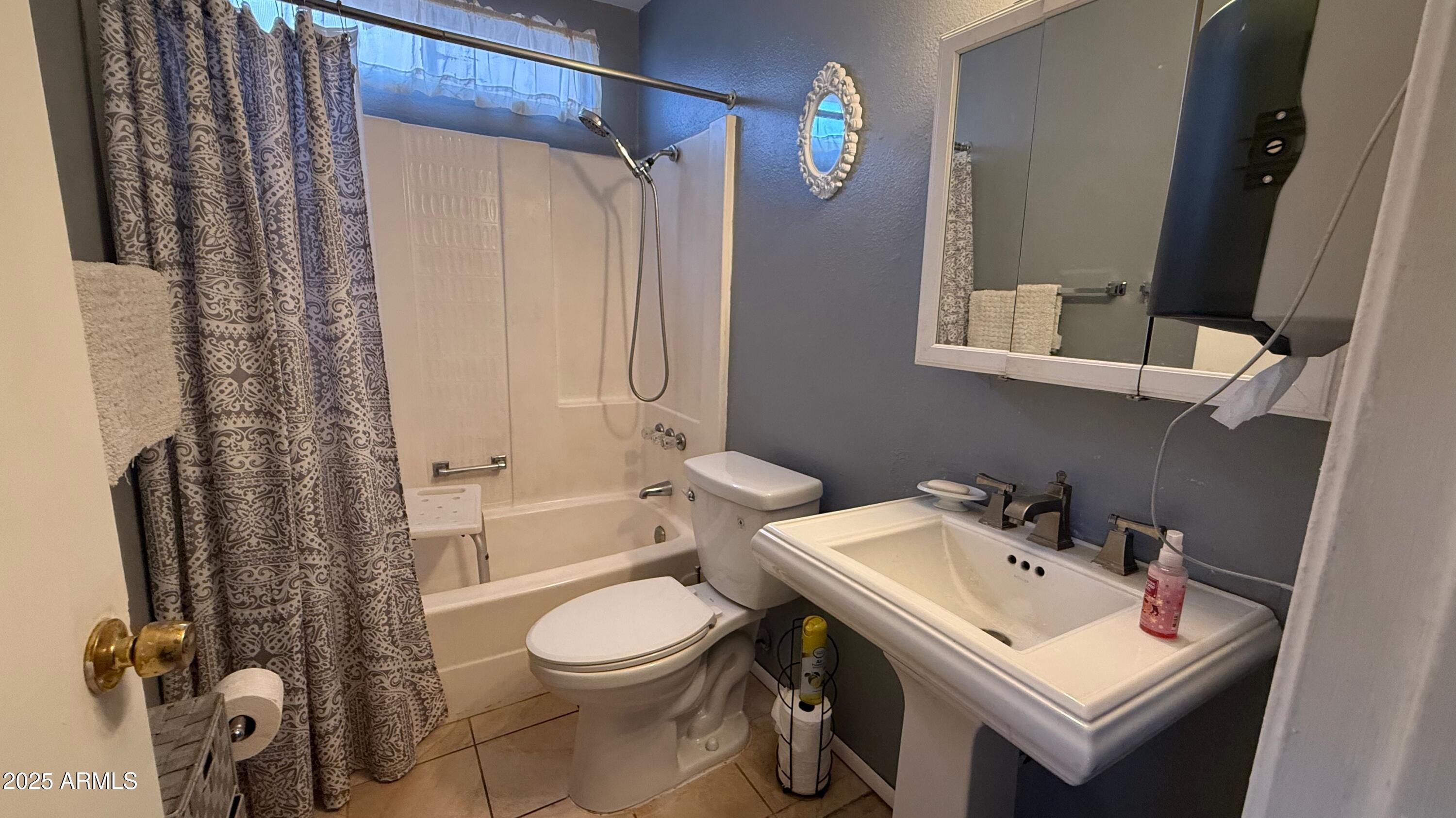 8524 West Weldon Avenue Phoenix, AZ 85037 - Photo 9 of 17 a bathroom with a sink toilet and shower
