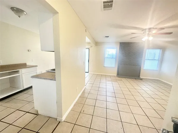 a view of a kitchen with white cabinets and white appliances