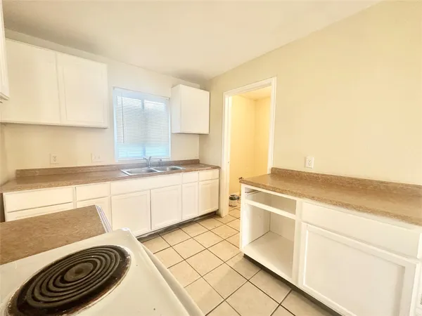a kitchen with a stove a sink and a refrigerator