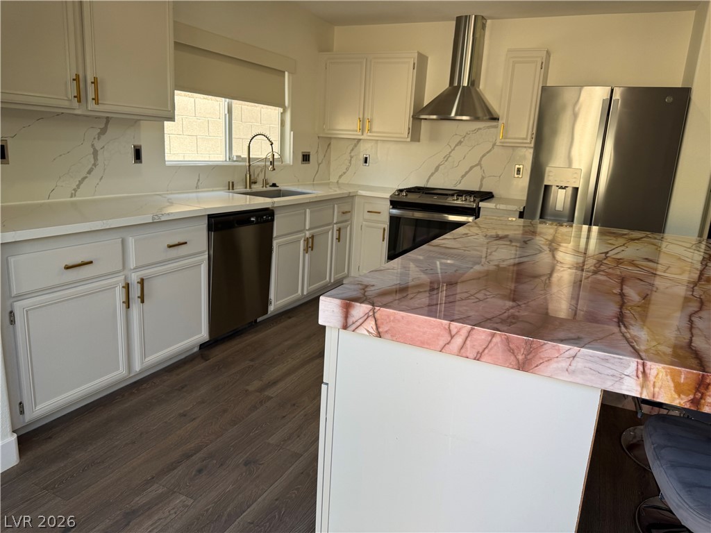1141 Cathedral Ridge Street Henderson, NV 89052 - Photo 16 of 77 This modern kitchen features elegant countertops, sleek cabinetry, and integrated appliances.
