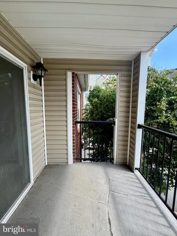a view of a porch with furniture and front door