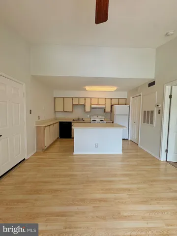 a view of a kitchen with wooden floor