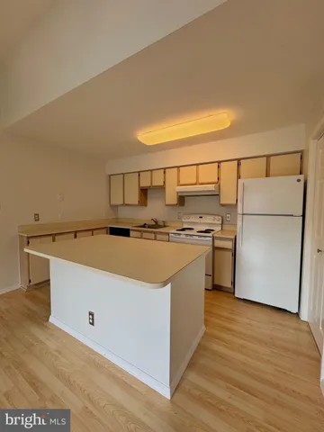 a kitchen with stainless steel appliances granite countertop a sink and a refrigerator