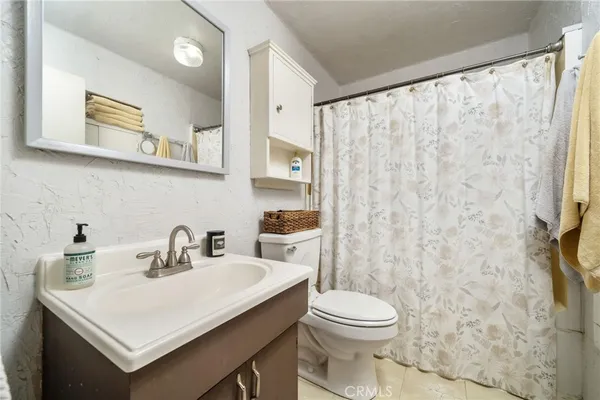 a living room with furniture a rug and a book shelf