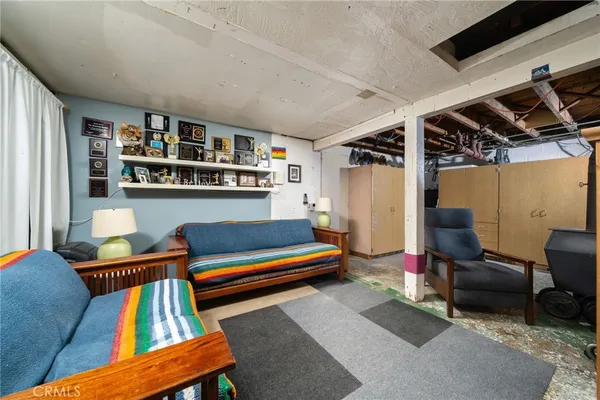 a living room with furniture rug and a window