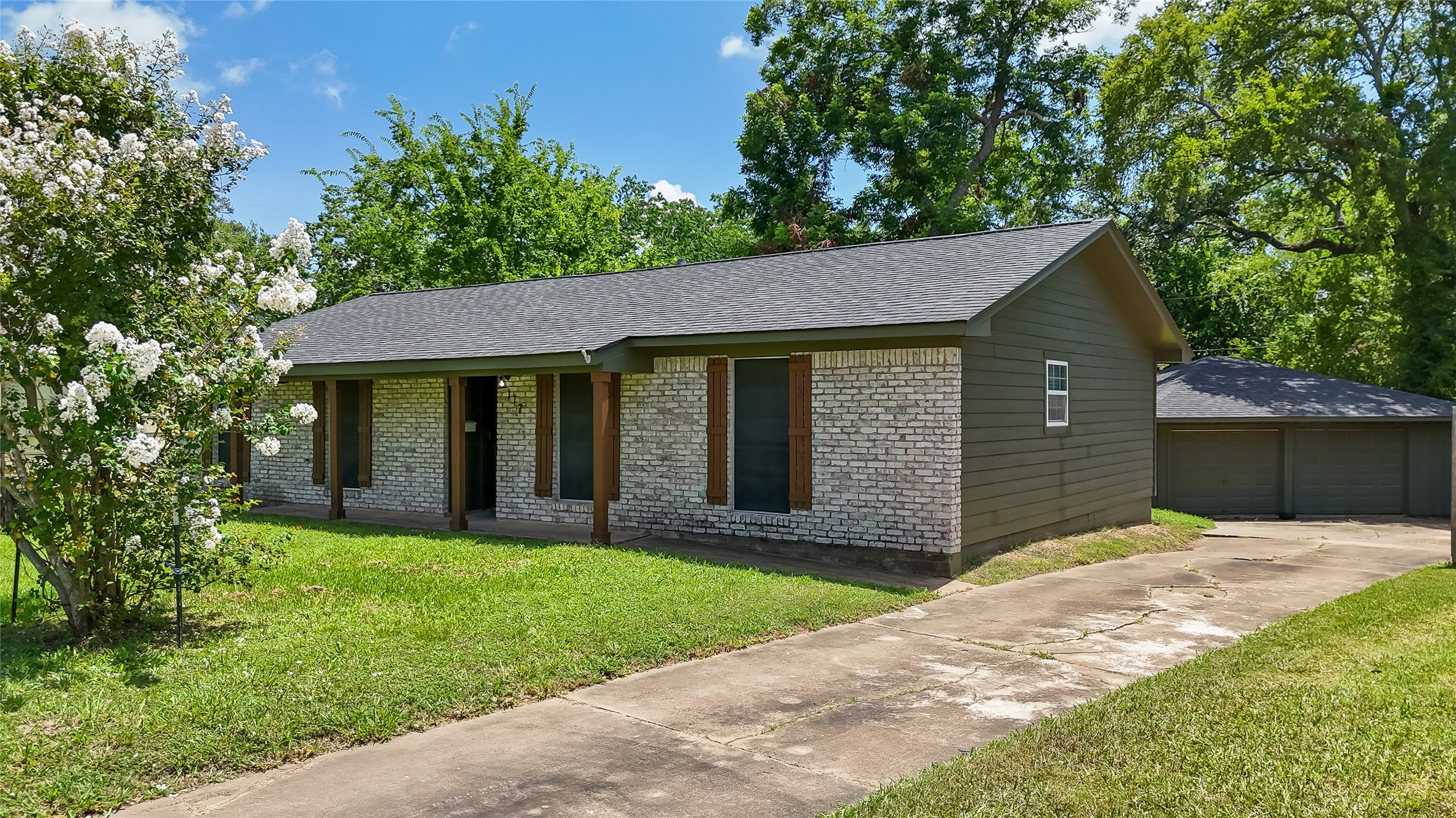 117 Cannon Street Clute, TX 77531 - Photo 6 of 24 A long driveway leads past the home, offering extra parking and easy access to the detached garage.