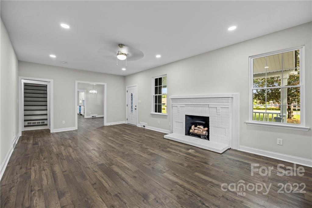 6000 Hickory Grove Road Charlotte, NC 28215 - Photo 24 of 40 a view of a livingroom with a fireplace wooden floor and window