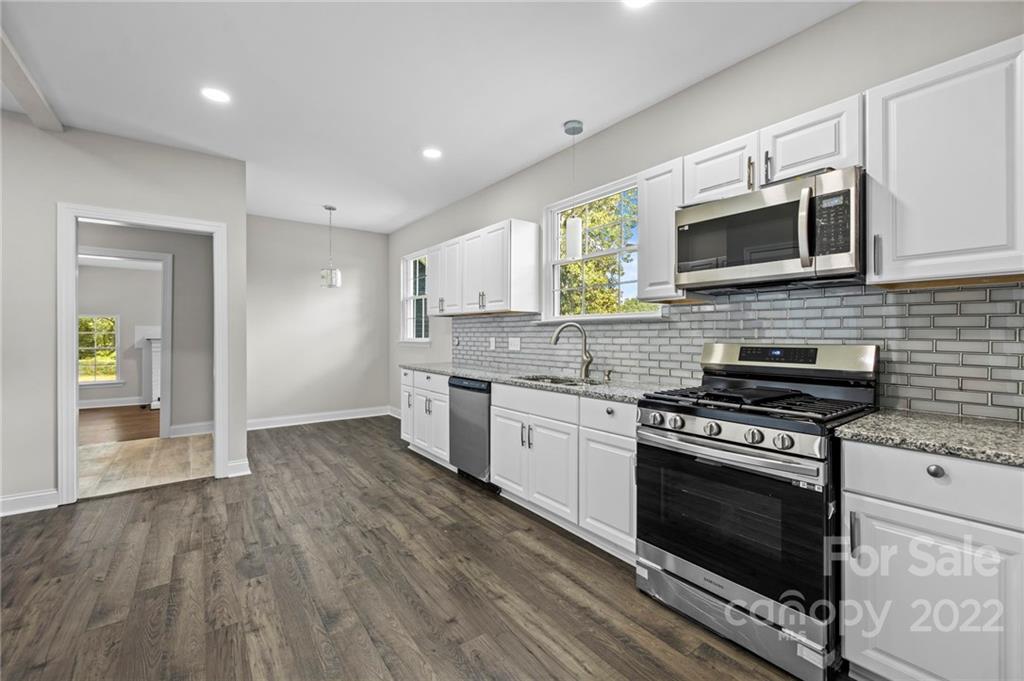 6000 Hickory Grove Road Charlotte, NC 28215 - Photo 26 of 40 a kitchen with stainless steel appliances granite countertop a stove and cabinets