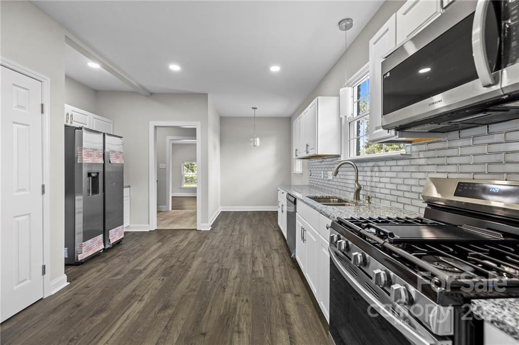 6000 Hickory Grove Road Charlotte, NC 28215 - Photo 29 of 40 a kitchen with stainless steel appliances granite countertop a stove and a refrigerator