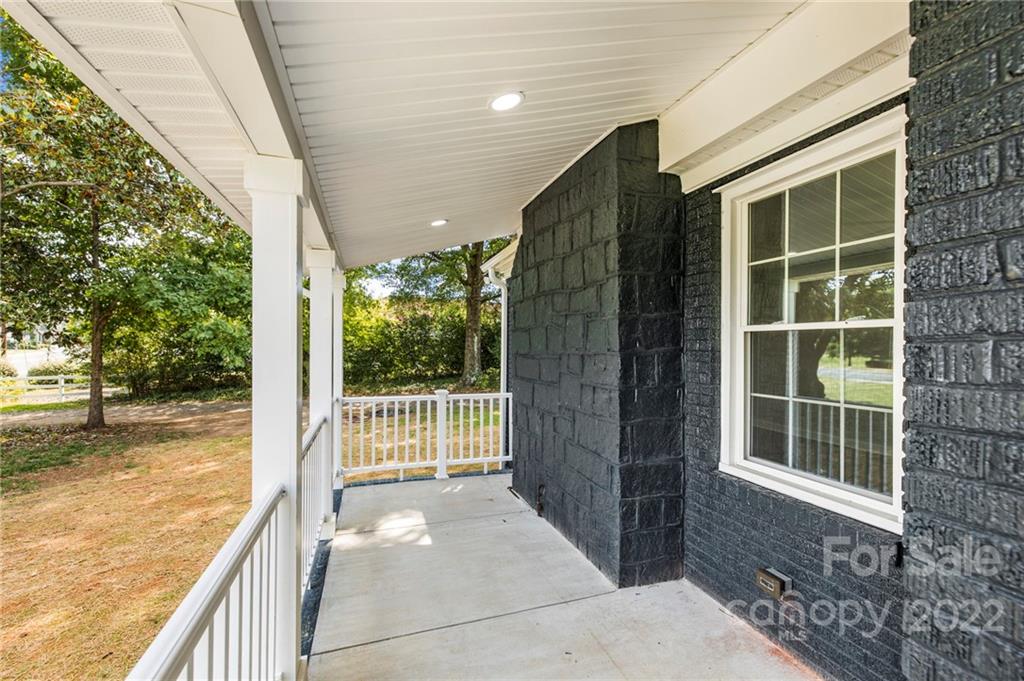 6000 Hickory Grove Road Charlotte, NC 28215 - Photo 5 of 40 a view of balcony with floor to ceiling window and wooden floor